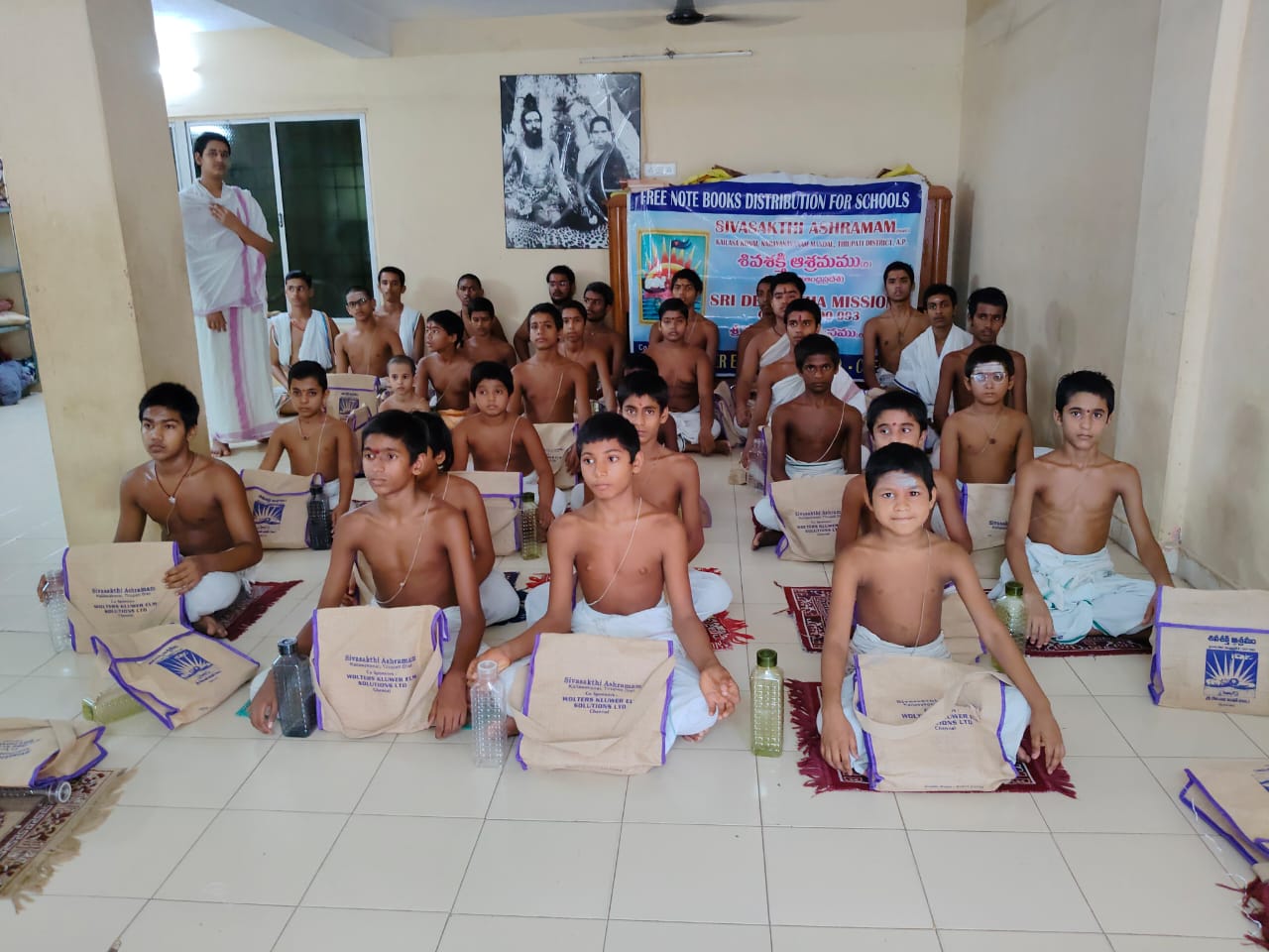 Veda Pāṭhaśālā students seated together with learning materials